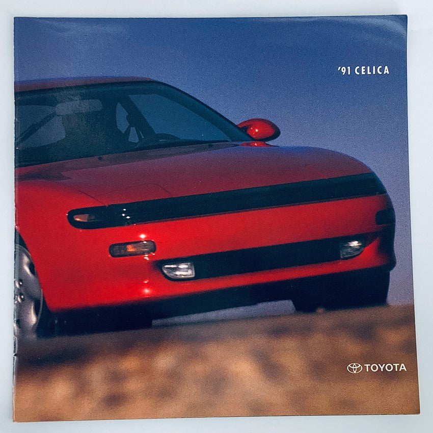 1991 Toyota Celica Dealer Showroom Sales Brochure Guide Catalog featuring a close-up view of a red Toyota Celica car against a blurred background.