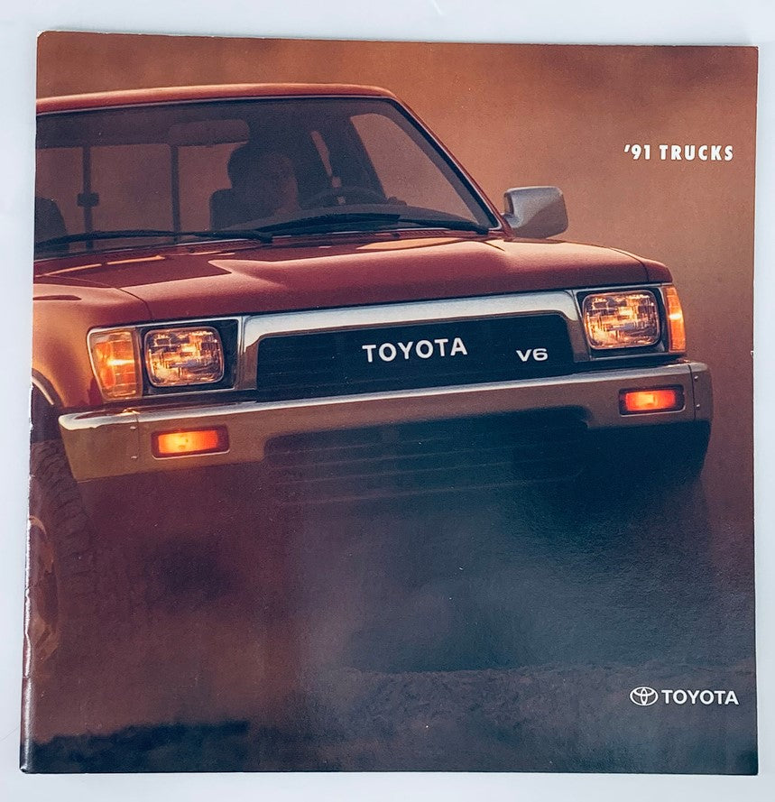 Cover of the 1991 Toyota Trucks V6 Dealer Showroom Sales Brochure Guide Catalog featuring a red Toyota truck in a scenic outdoor setting.