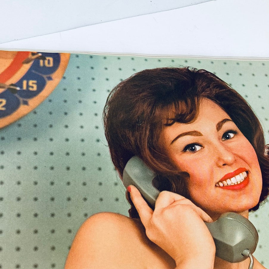 Inside page of VTG Playboy Magazine April 1962 featuring a woman smiling and talking on the phone, highlighting the vintage fashion of the era.