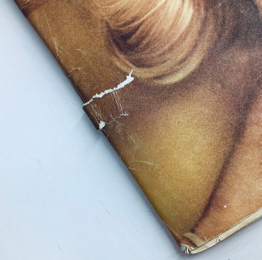 Close-up view of the spine of the VTG Playboy Magazine May 1961, showing subtle wear and tear, highlighting its vintage condition.