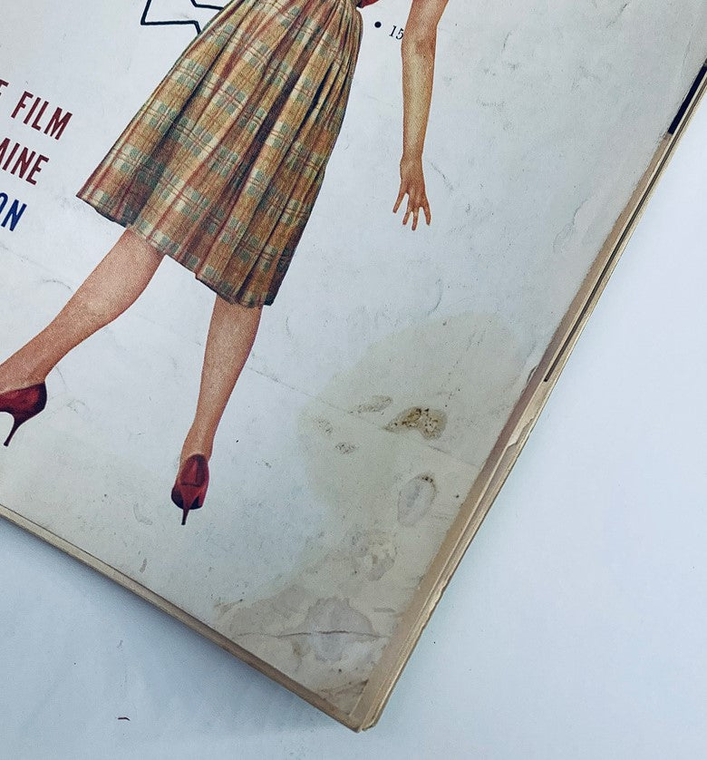 Cover of VTG Playboy Magazine October 1959 featuring model in plaid dress and vintage high heels. Iconic representation of mid-century fashion.