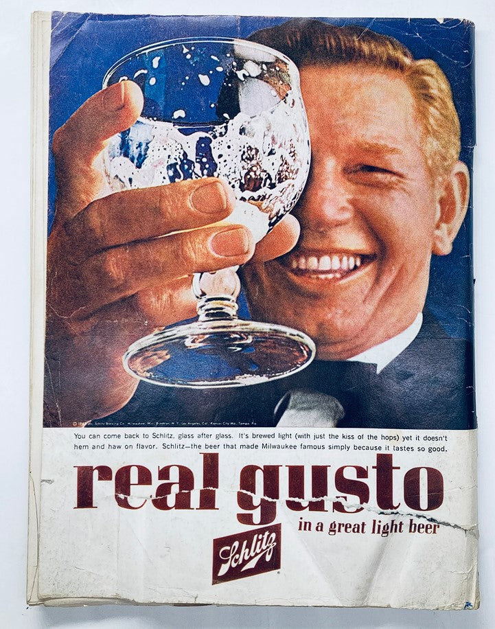 Full image of Schlitz beer advertisement from April 1963 Playboy Magazine, showing a man holding a beer glass and smiling, promoting the slogan 'real gusto'.