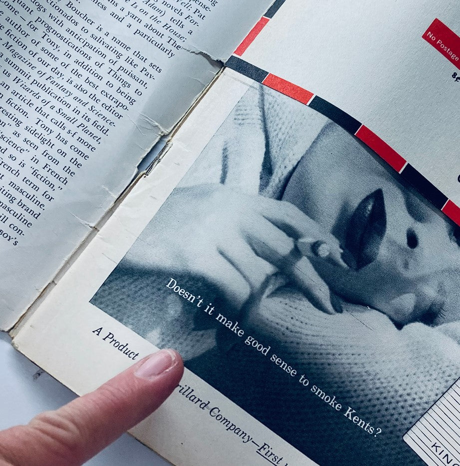 Interior page of VTG Playboy Magazine May 1958 featuring a vintage advertisement with a hand holding a cigarette, showcasing the magazine's historical advertisements.