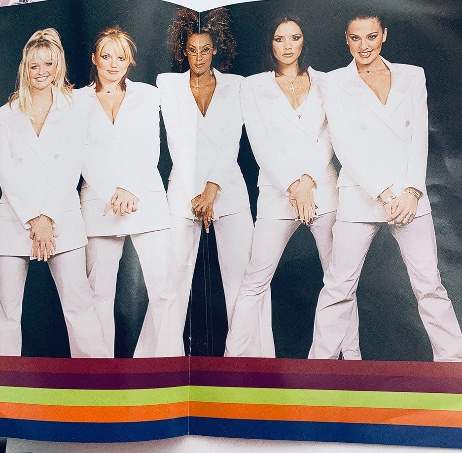 1998 Spice Girls - Spice World The Tour Program featuring the five members of the iconic girl group dressed in stylish white suits, showcasing a vibrant pop culture moment from the late 90s.