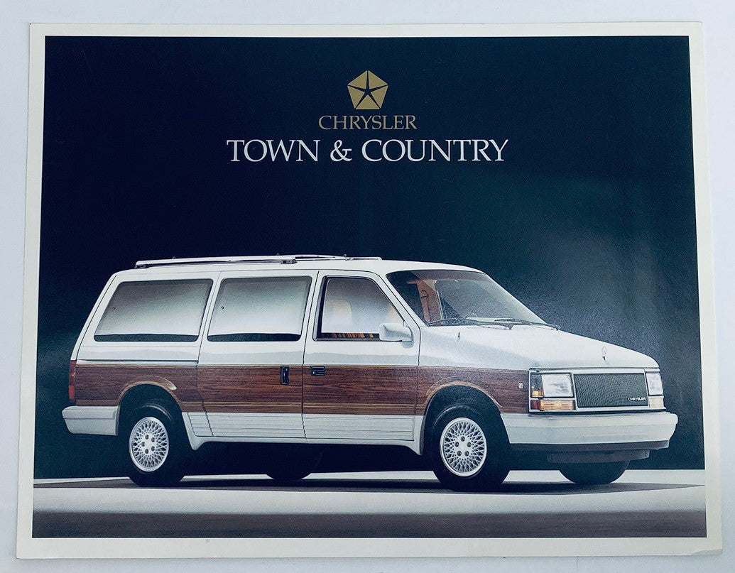 1990 Chrysler Town & Country dealer showroom sales brochure showcasing the classic minivan design with a wood panel exterior, featuring stylish wheels and an elegant setting.