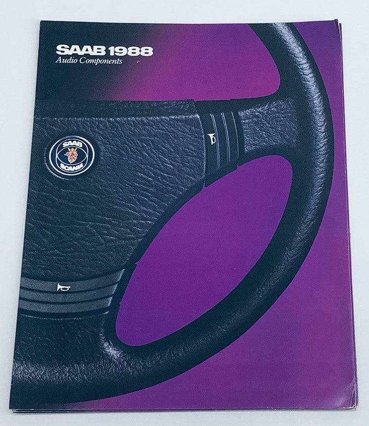 Cover of the 1988 Saab Audio Components Dealer Showroom Sales Brochure Catalog featuring a black leather steering wheel and a purple background.
