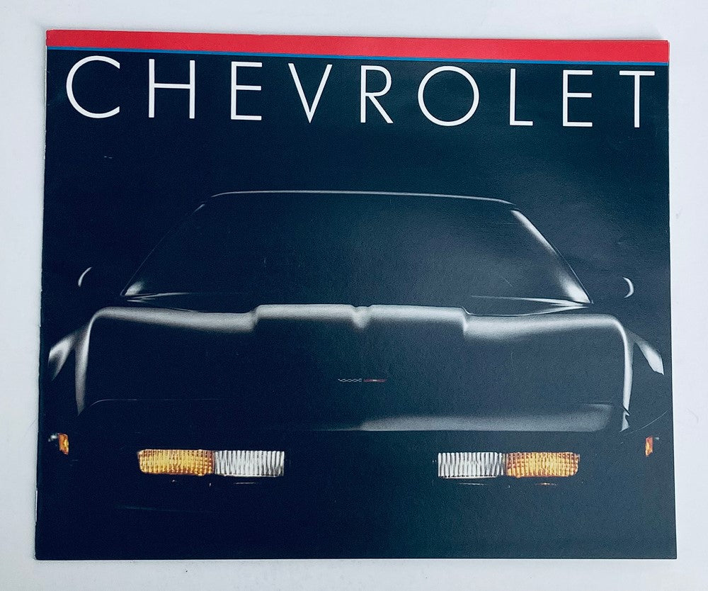 1983 Chevrolet Corvette Dealer Showroom Sales Brochure featuring a sleek front view of the Corvette, highlighting its iconic design and headlights.