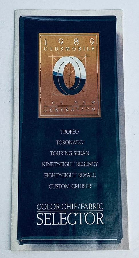 1989 Oldsmobile Trofeo, Toronado Dealer Showroom Sales Brochure Cover featuring the logo and list of models including Trofeo, Toronado, Touring Sedan, and more.