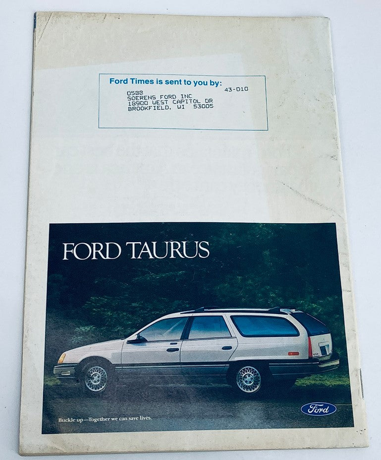 Back cover of the VTG Ford Times Magazine May 1988 featuring an advertisement for the Ford Taurus, showcasing its design with a scenic forest background. Perfect for collectors of vintage magazines and automotive enthusiasts.