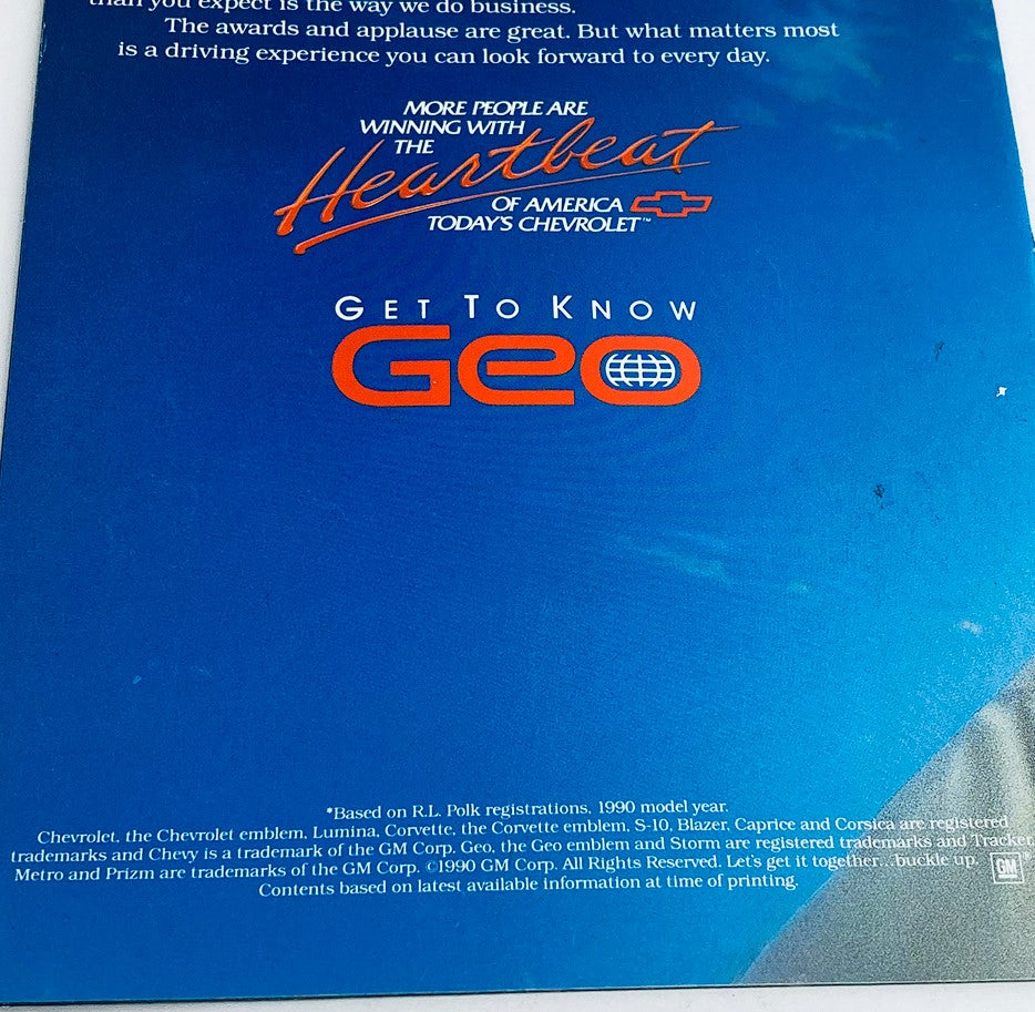 Back cover of the 1990 Geo Full Lineup Dealer Showroom Sales Guide Catalog displaying promotional text about Chevrolet and Geo vehicles with a bright blue background and the phrase 'Get to Know Geo.'