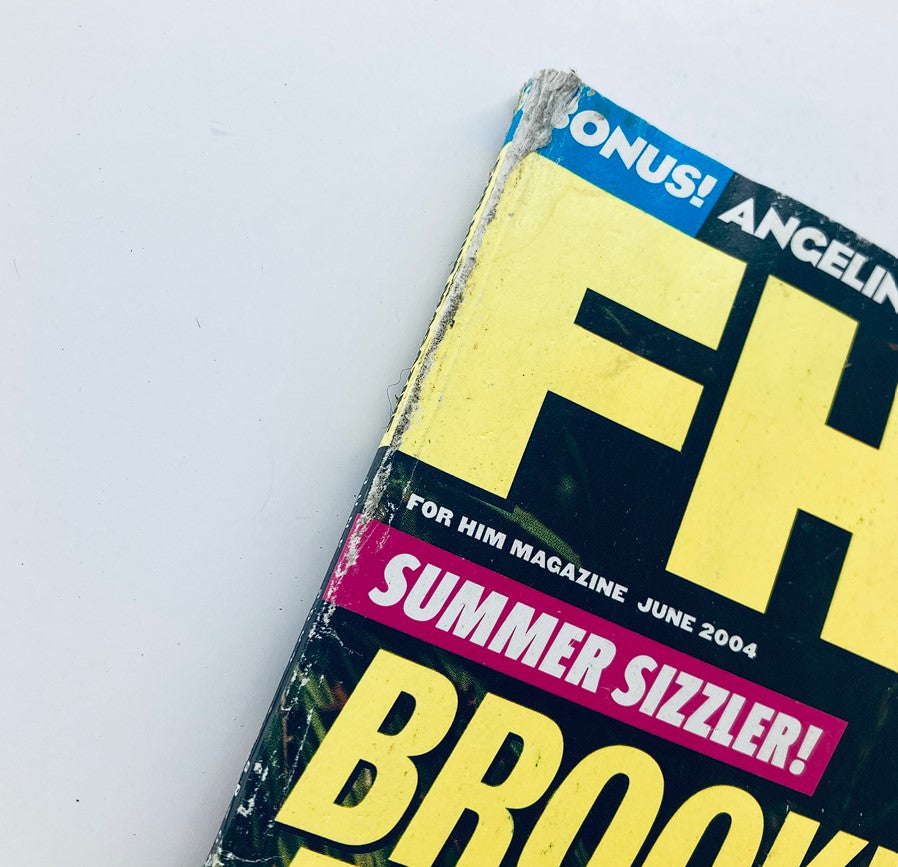 Close-up of the edge of FHM Magazine June 2004, highlighting wear and tear, with the title prominently displayed along with 'Summer Sizzler!' featuring Brooke Burke.