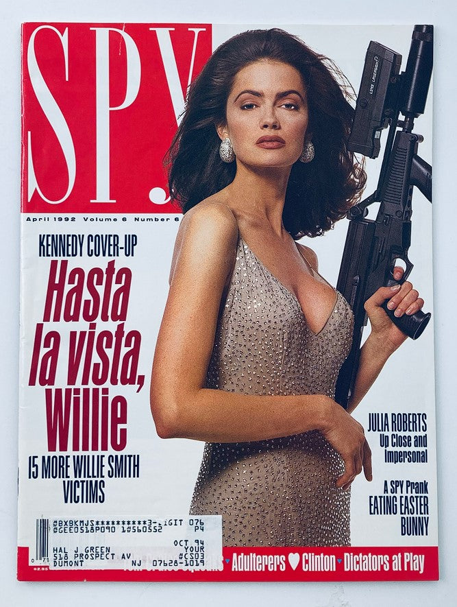 Cover of Spy Magazine, April 1992 issue featuring Michelle Turley photographed by Carolyn Jones, showcasing edgy pop culture with a striking model holding a weapon and dressed in an elegant gown.