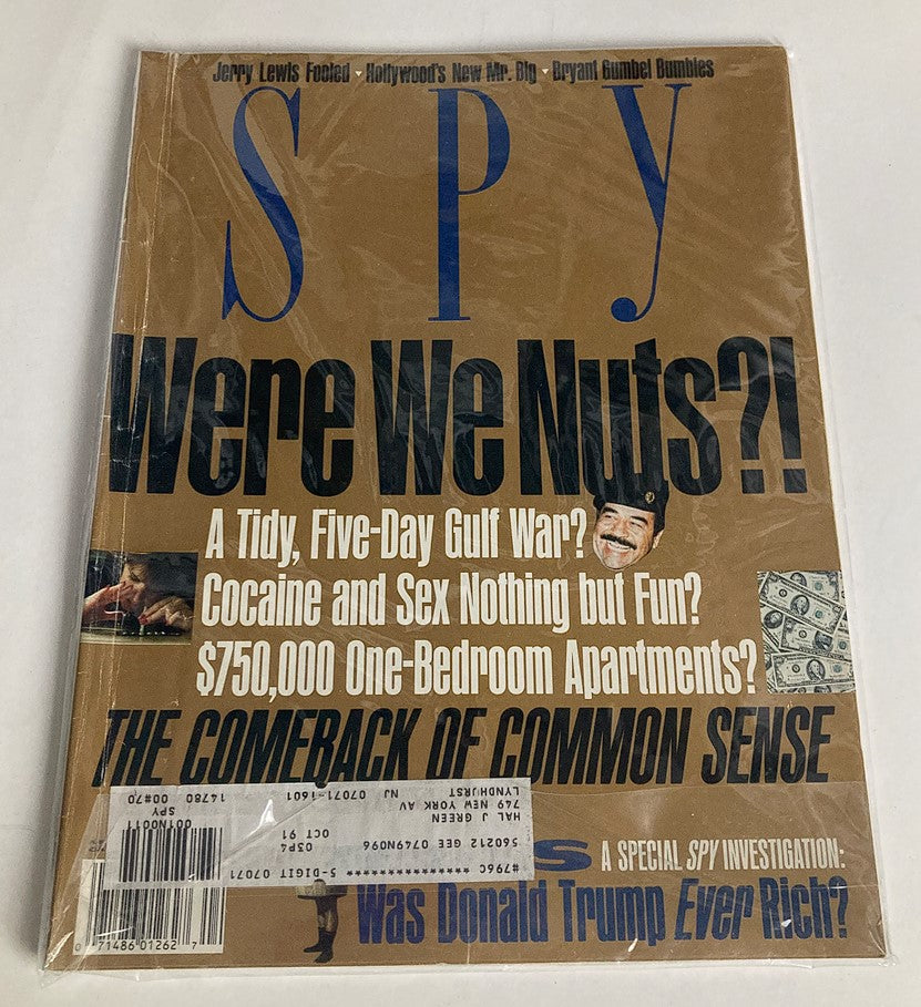 Spy Magazine April 1991 cover displayed in protective plastic, highlighting the themes of wealth and media scrutiny in America with the question 'Was Donald Trump Ever Rich?'. The cover also features intriguing headlines related to current events of the time.