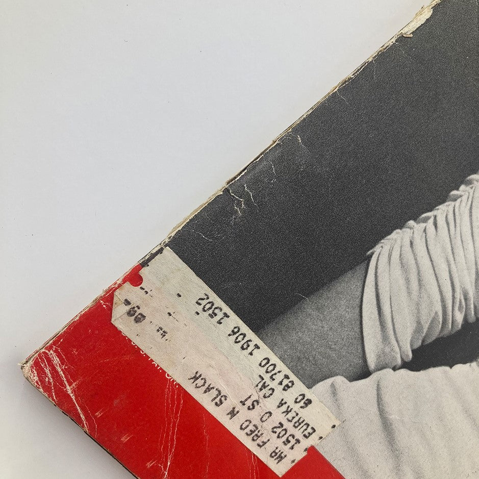 Close-up view of the corner of the VTG Life Magazine April 7 1952 featuring Marilyn Monroe, showing wear and tags indicative of its vintage condition.