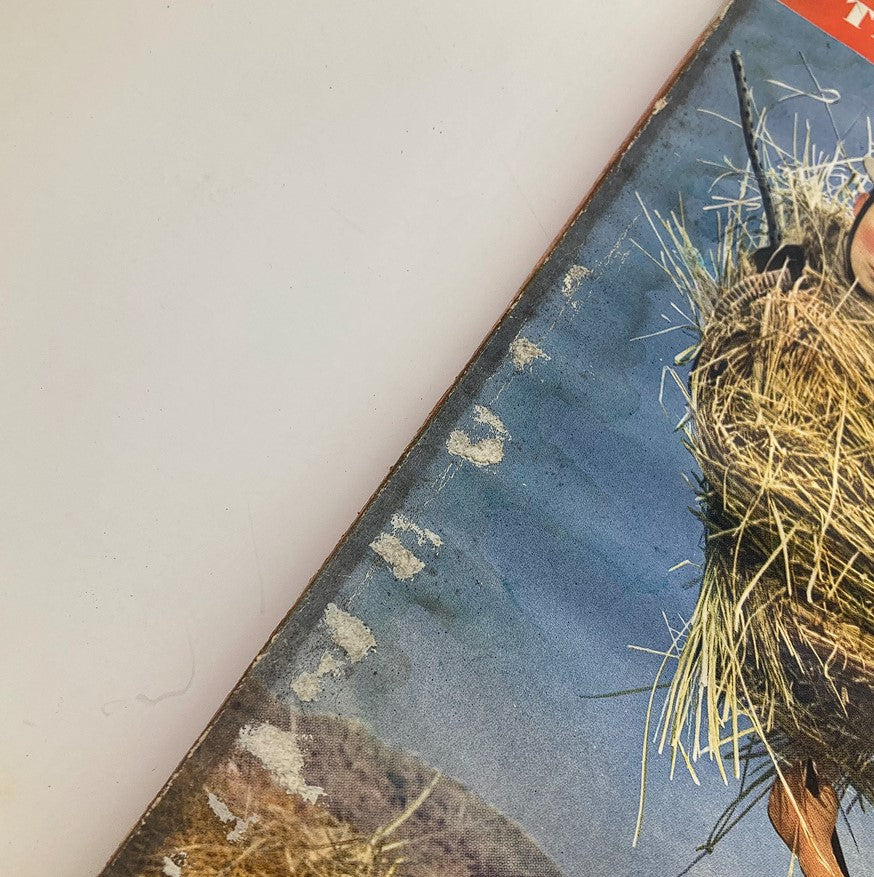 Close-up view of the front cover of the VTG Esquire Magazine Victory Issue August 1942 showing wear and tear with visible creases, reflecting its vintage history.