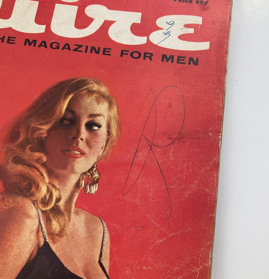 Close-up of the cover of VTG Esquire Magazine March 1957 Vol 47 #3, highlighting a glamorous woman with long blonde hair and a distinctive hairstyle.