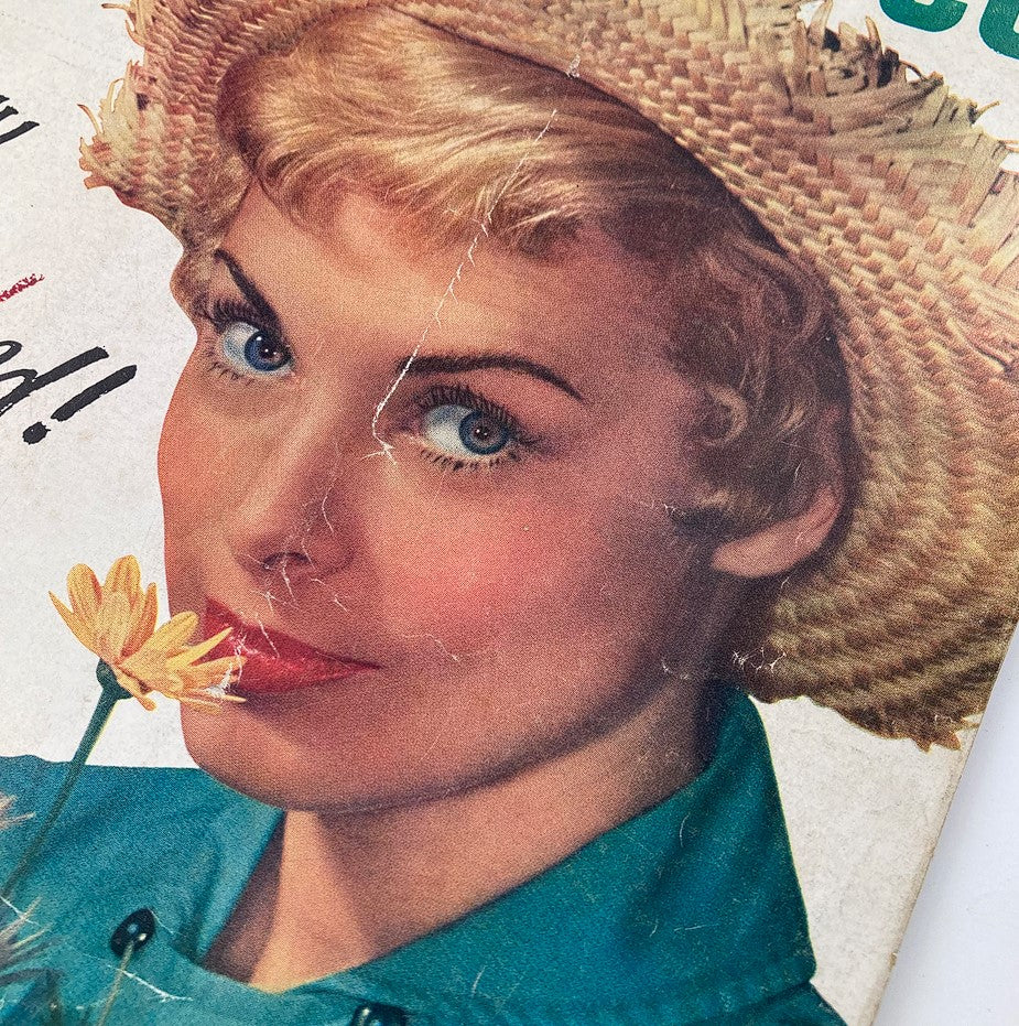 Close-up of Janet Leigh on the cover of VTG Modern Screen Magazine September 1957, highlighting her stunning look with a flower in her mouth and stylish hat.