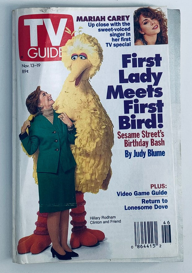 Cover of TV Guide Magazine November 13, 1993, featuring Hillary Clinton and Big Bird, with a headline about Mariah Carey. Highlights include 'First Lady Meets First Bird' and 'Sesame Street's Birthday Bash', showcasing a blend of political and entertainment culture in the early 90s.