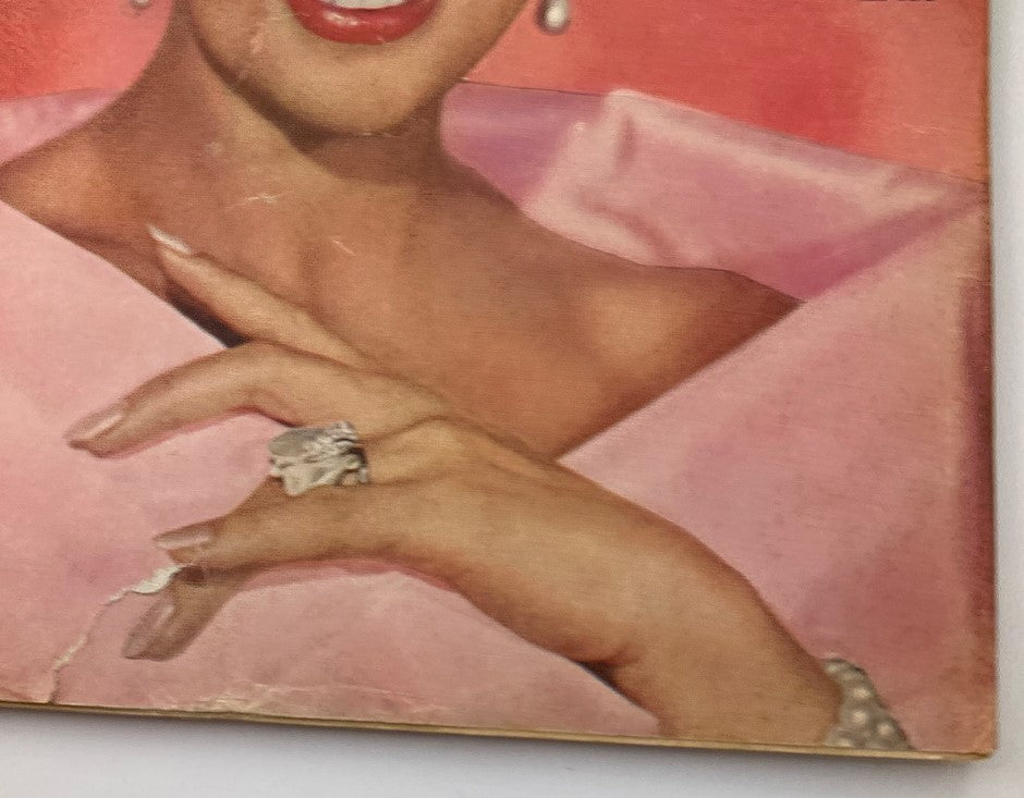 Detail view of Loretta Young's hand and jewelry from the April 1961 Radio TV Mirror Magazine, highlighting vintage fashion.