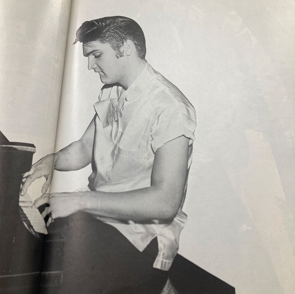 Black and white photograph of Elvis Presley playing piano featured in VTG 1978 Elvis Presley The Legend Lives On magazine.