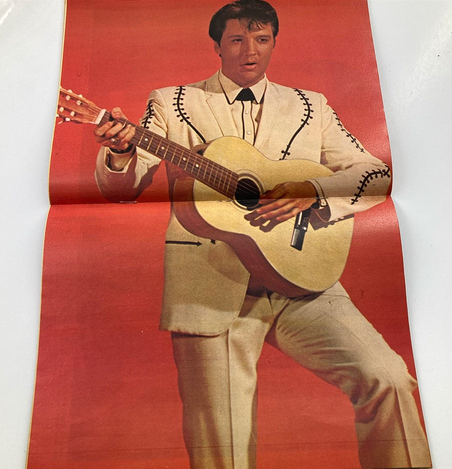 Fold-out poster from VTG Manor Magazine 1977 'The Life and Death of Elvis Presley,' featuring Elvis dressed in a stylish outfit playing guitar, capturing a significant moment in his musical career.