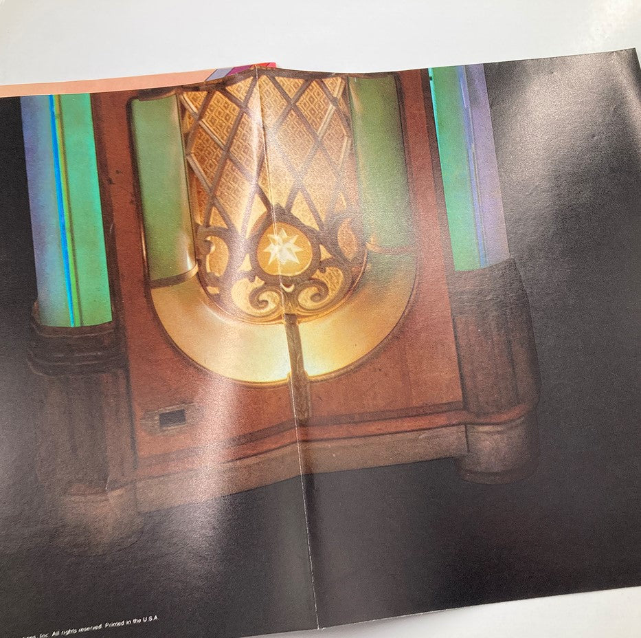 Interior image from VTG Dynamite Magazine 1976 No. 24, showcasing a classic vintage jukebox with colorful lights and intricate design details.