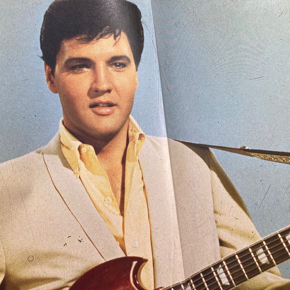 Elvis Presley performing with a guitar in the VTG Rock Stars Magazine 1987, capturing his influential musical presence.
