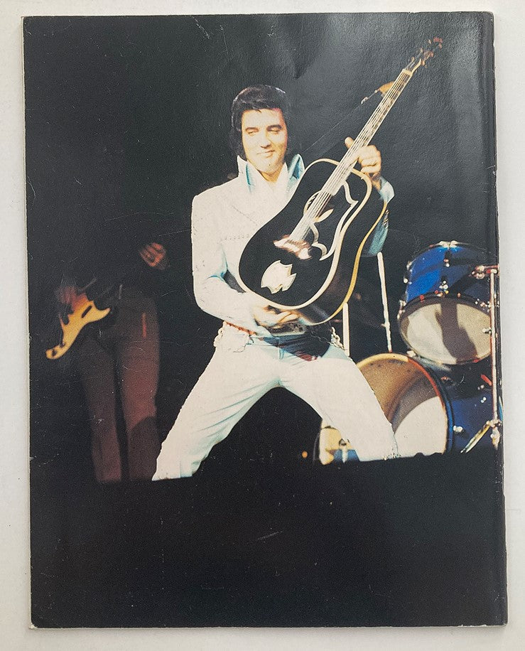 Elvis Presley performing live, holding a guitar on stage, featured in the Elvis International Forum Winter 1993 Vol 6 #4 with a dramatic concert backdrop.