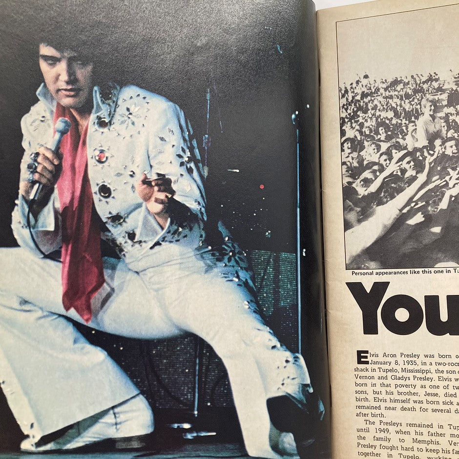 VTG 1987 Elvis Presley in Concert Official Collector's Edition inside page showing Elvis in a sequined outfit during a performance. The page highlights Elvis's dynamic stage presence and includes historical information about the legendary artist.