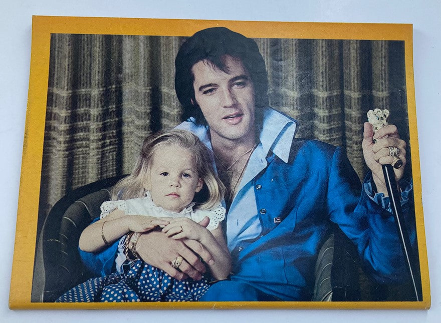 Vintage Platinum Magazine 1979 issue featuring Elvis Presley holding a child, showcasing the iconic look and style of the King of Rock 'n' Roll, accompanied by nostalgic imagery from the 1970s.