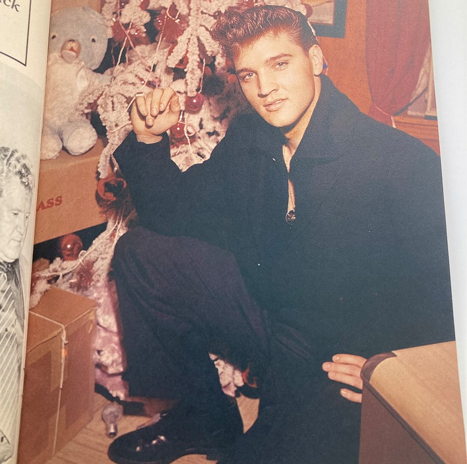Page from VTG Modern Screen Presents 1979 No. 1 Elvis Presley magazine depicting Elvis Presley posed beside a holiday setting with a Christmas tree.