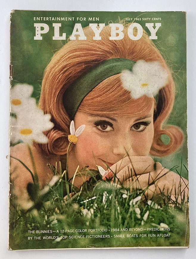 Vintage Playboy Magazine July 1963 cover featuring Miss Carrie Enwright, showcasing her with flowers in her hair, appealing to collectors and enthusiasts.