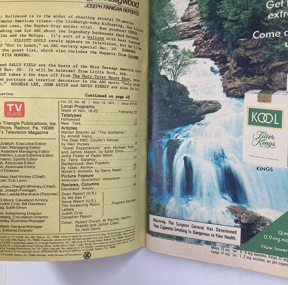 Inside page of TV Guide Magazine November 16 1974 Issue #1129 showing listings and articles, including teletype updates and feature stories related to the entertainment industry. Includes a scenic advertisement for Kool cigarettes.