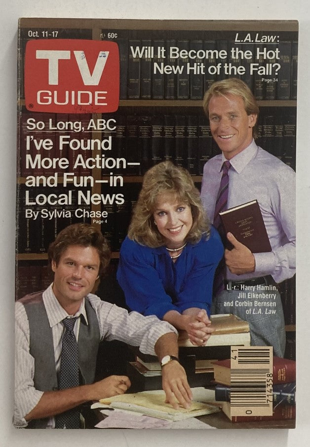 TV Guide Magazine October 11 1986 featuring a cover photo of actors Harry Hamlin, Jill Eikenberry, and Corbin Bernsen discussing local news and the new TV show L.A. Law. A collectible magazine showcasing 1980s television history.