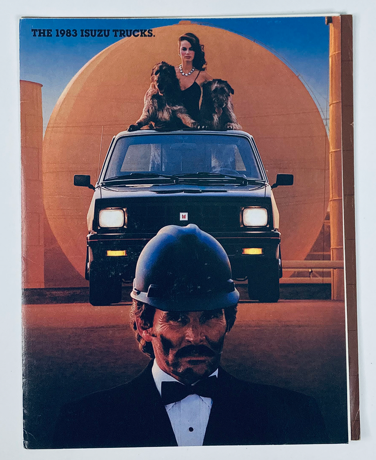 Cover of the 1983 Isuzu Trucks Dealer Showroom Sales Brochure Guide Catalog featuring an image of a truck, a woman in elegant attire, and two dogs. The background showcases a stylized industrial setting.