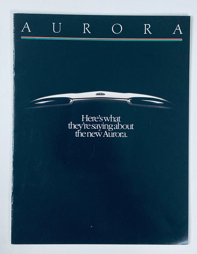 1995 Oldsmobile Aurora Dealer Showroom Sales Brochure Guide Catalog cover featuring a sleek image of the car and the tagline 'Here's what they're saying about the new Aurora.'