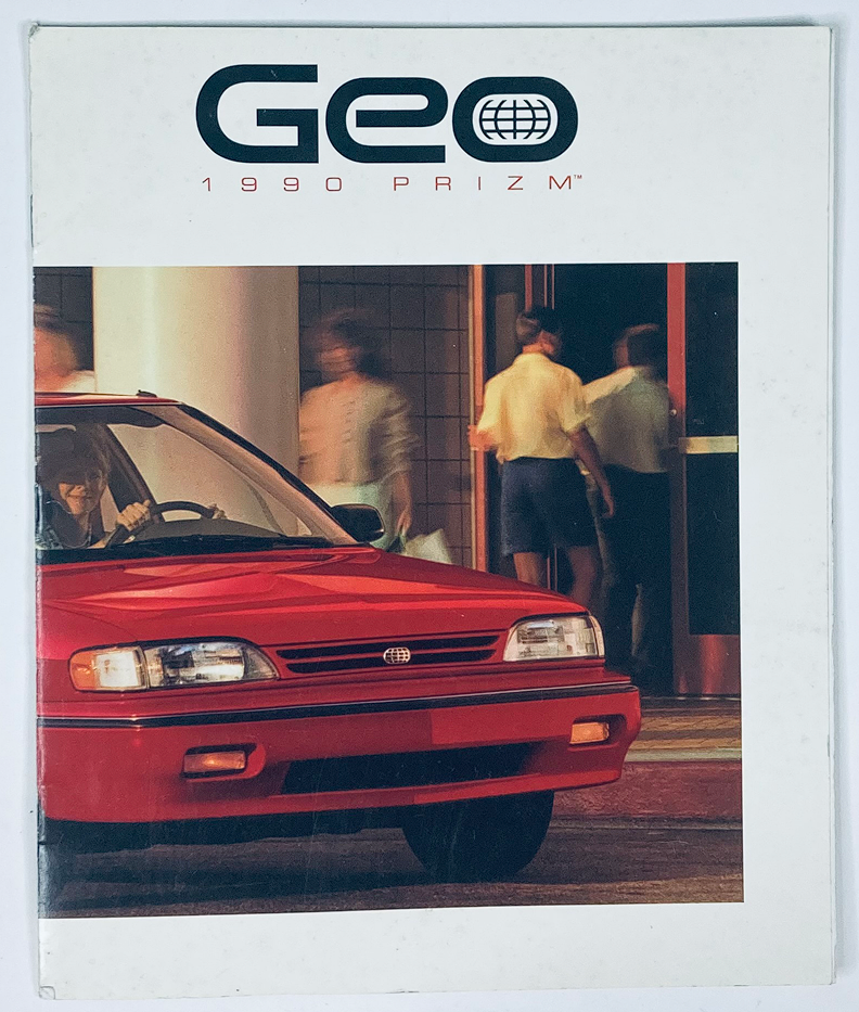 1990 Geo Prizm Dealer Showroom Sales Brochure featuring the red Geo Prizm parked in front of an entrance, showcasing the vehicle's design and appeal.