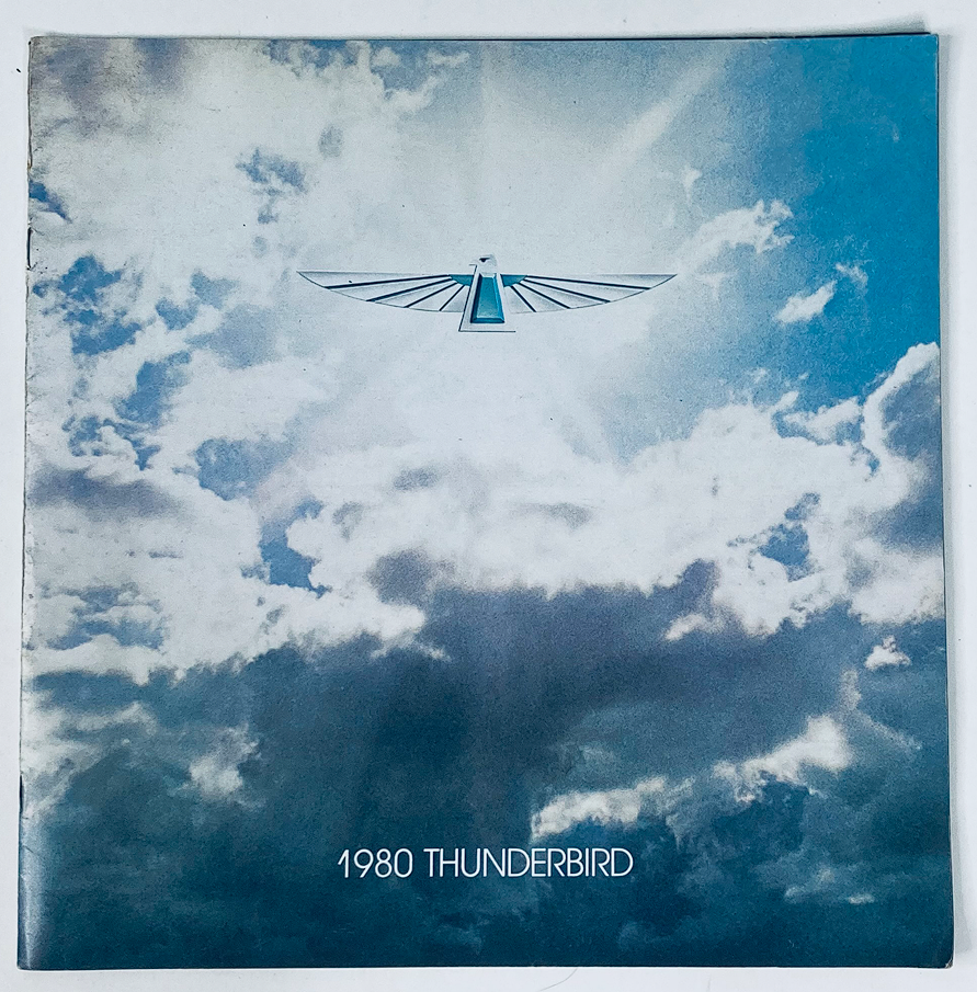 Cover of the 1980 Ford Thunderbird Dealer Showroom Sales Brochure Guide Catalog featuring a blue sky with clouds and the Thunderbird logo in the center, showcasing the model year.