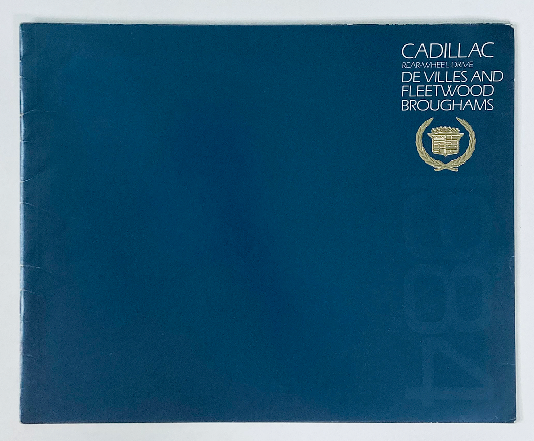 Cover of the 1984 Cadillac De Villes Dealer Showroom Sales Brochure Guide Catalog featuring a blue design with text indicating 'Cadillac Rear-Wheel-Drive De Villes and Fleetwood Broughams' and an emblem logo, perfect for automotive enthusiasts and collectors.