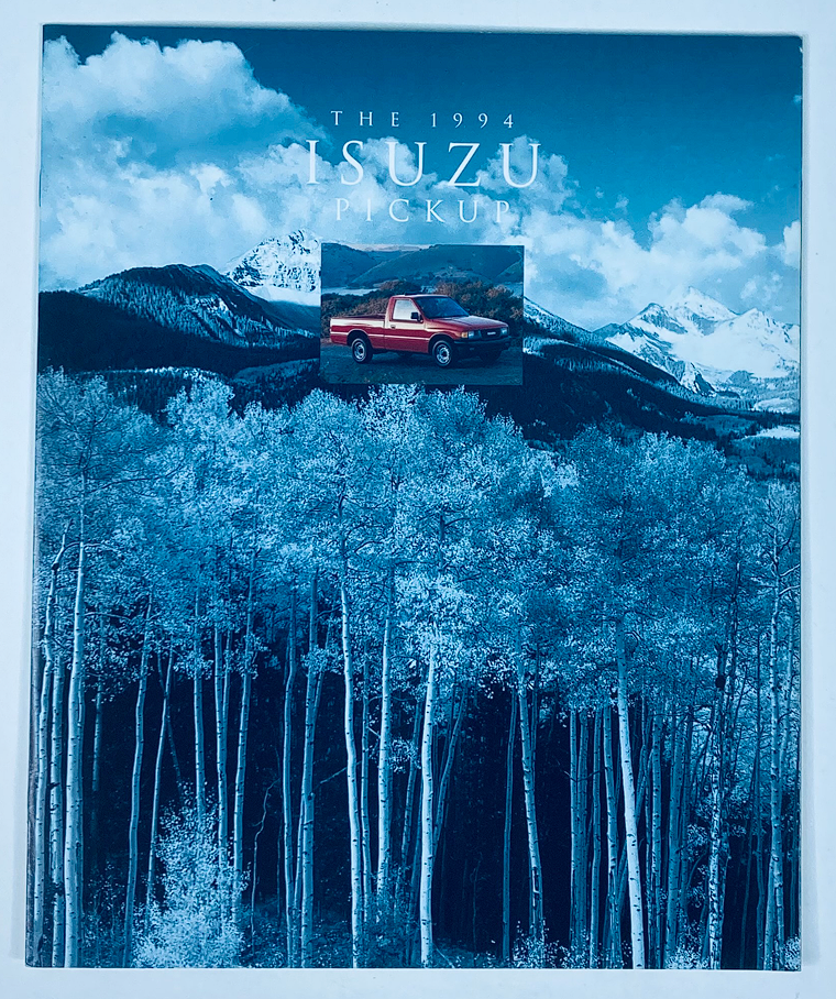 Cover of the 1994 Isuzu Pickup Lineup Dealer Showroom Sales Brochure, featuring a scenic mountain backdrop and a red Isuzu pickup truck.