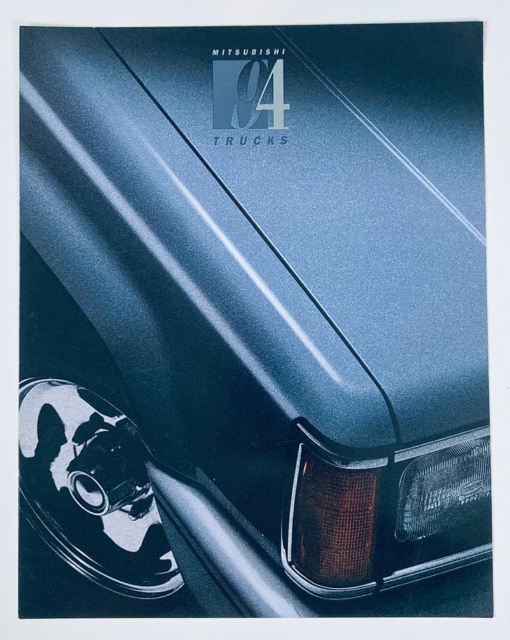 Close-up image of a 1994 Mitsubishi Trucks Dealer Showroom Sales Brochure showcasing the truck's sleek design and detailing. Featuring the title '1994 Mitsubishi Trucks Dealer Showroom Sales Brochure Guide Catalog'.