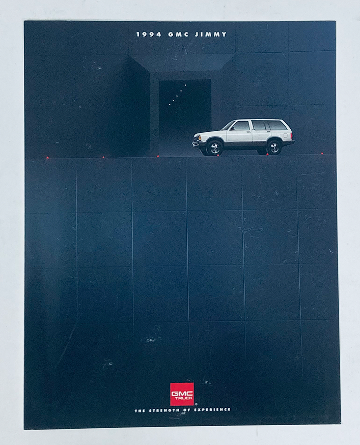 1994 GMC Jimmy Dealer Showroom Sales Brochure featuring a GMC Jimmy SUV against a dark minimalist background. Ideal for collectors and automotive enthusiasts.