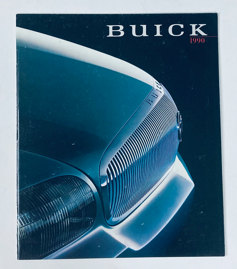 1990 Buick Dealer Showroom Sales Brochure Guide Catalog featuring a close-up of a Buick vehicle's front grille, showcasing its sleek design and iconic branding.