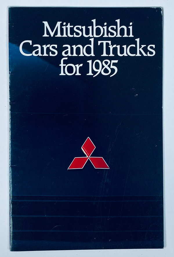 Cover of the 1985 Mitsubishi Cars & Trucks Dealer Showroom Sales Brochure Guide Catalog, featuring the Mitsubishi logo and text stating 'Mitsubishi Cars and Trucks for 1985'.