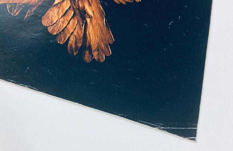 Detail of the bottom corner of the 1983 Buick Dealer Showroom Sales Brochure Guide Catalog, showcasing worn edges and vintage texture.