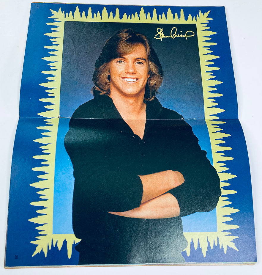 Inside of VTG SuperMag Magazine Vol 2 No. 10 showing a mini-poster of a male model with long hair and arms crossed.