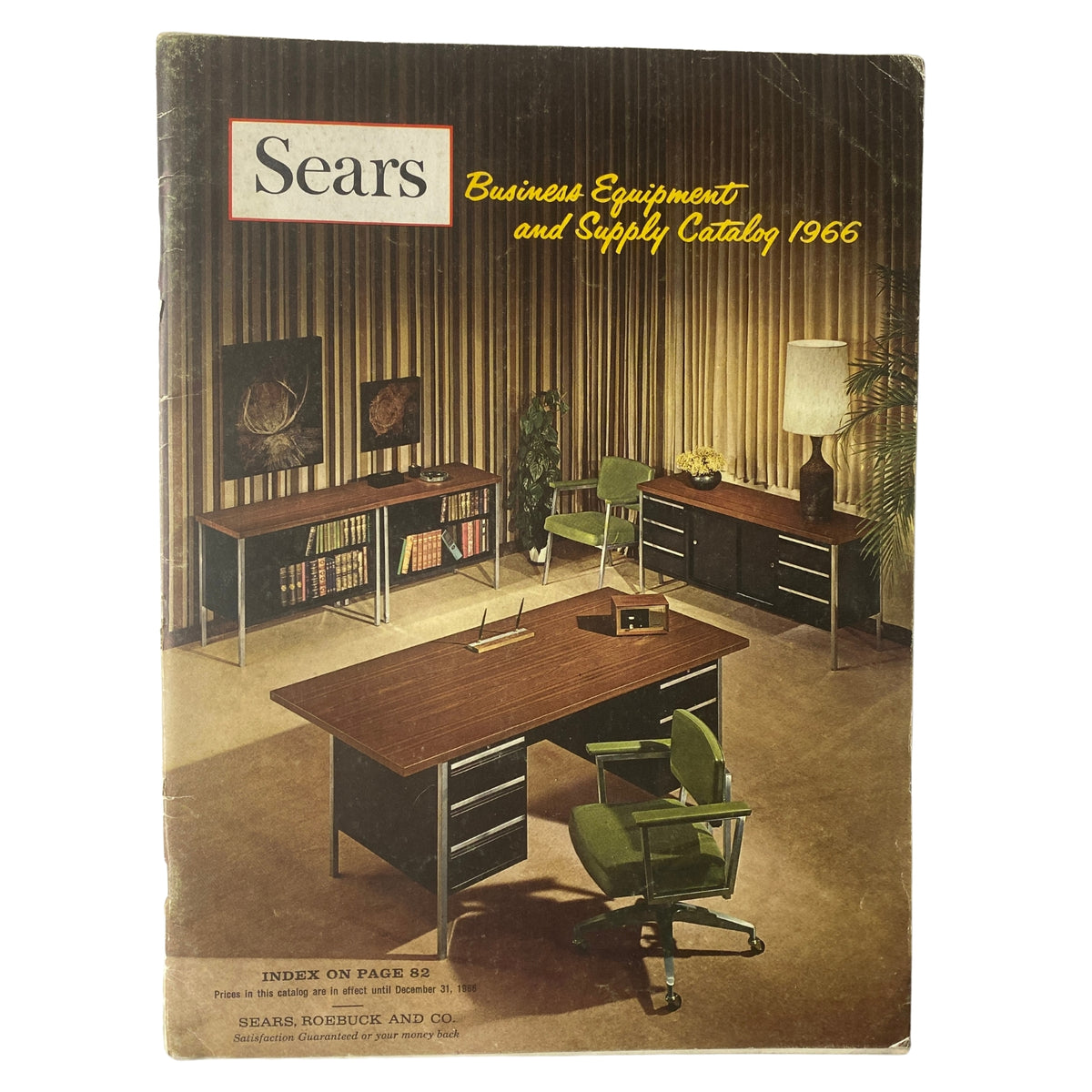 1966 Sears Business Equipment and Supply Catalog cover featuring an office setting with a dark wood desk, green chairs, and shelves, showcasing the office design trends of the 1960s.