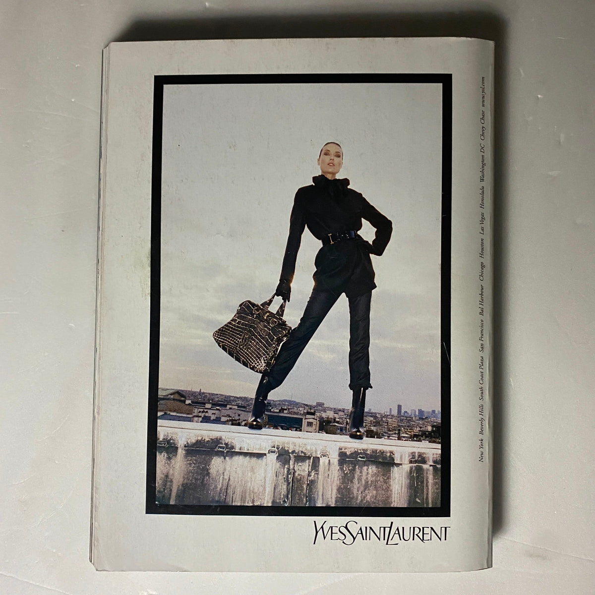Back cover of Elle Magazine October 2006 featuring a model in Yves Saint Laurent attire with a cityscape.