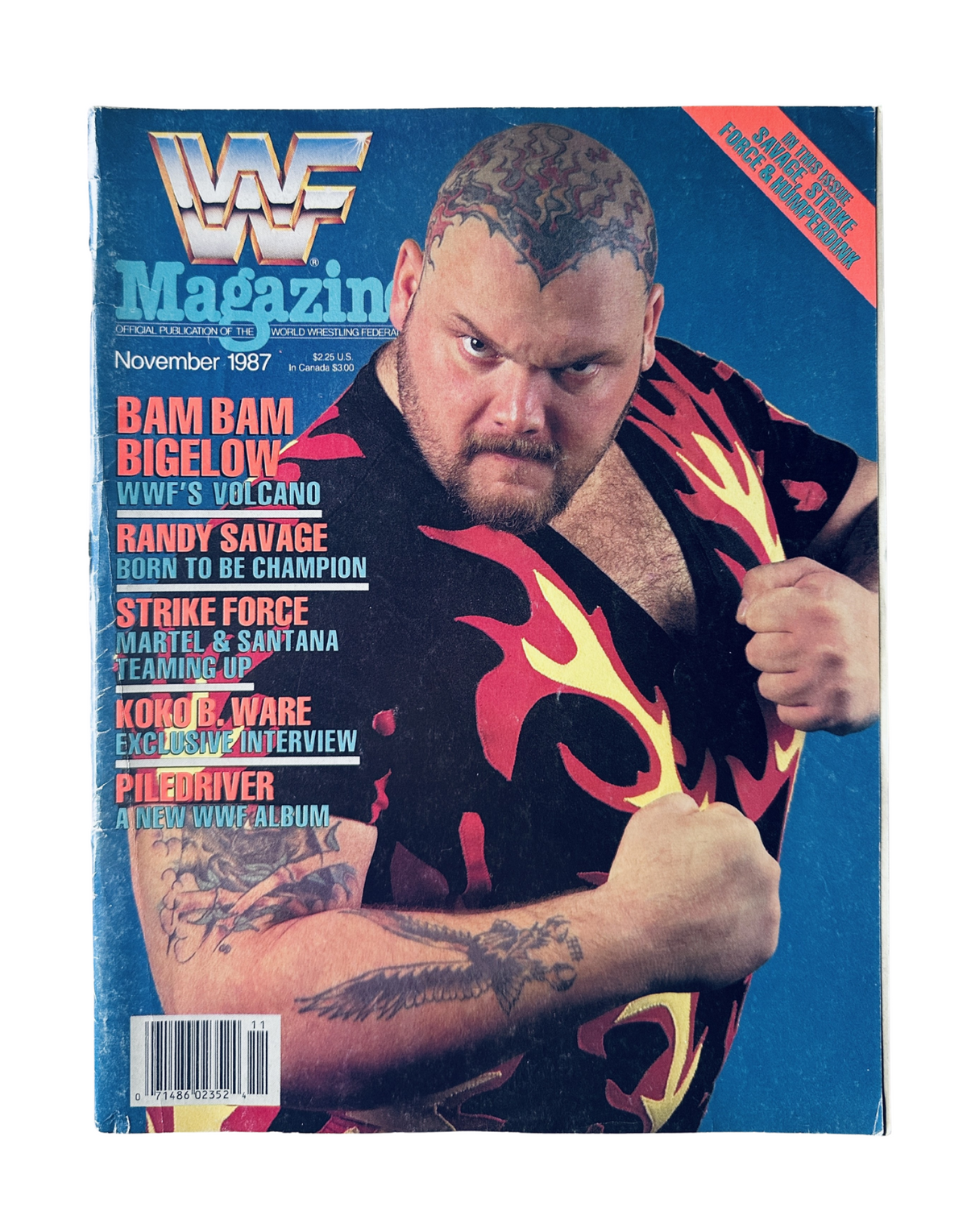 Cover of WWF Magazine November 1987 featuring Bam Bam Bigelow, showcasing his imposing presence with a fierce expression and vibrant flaming shirt.