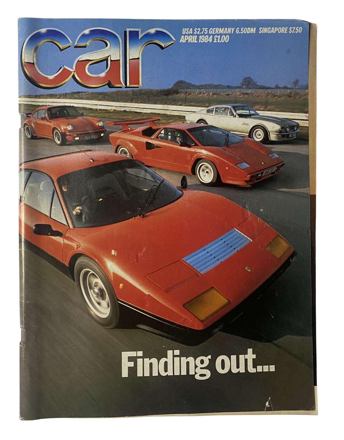 Cover of CAR Magazine April 1984 featuring Ferrari 512BB, Lamborghini Countach, and Porsche 911 Turbo, highlighting supercar comparison.